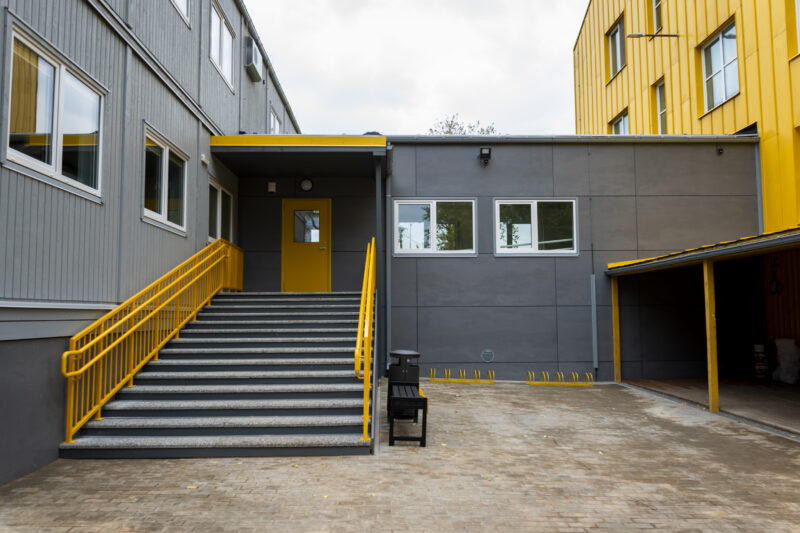 Completed modular school building with entrance and access stairs